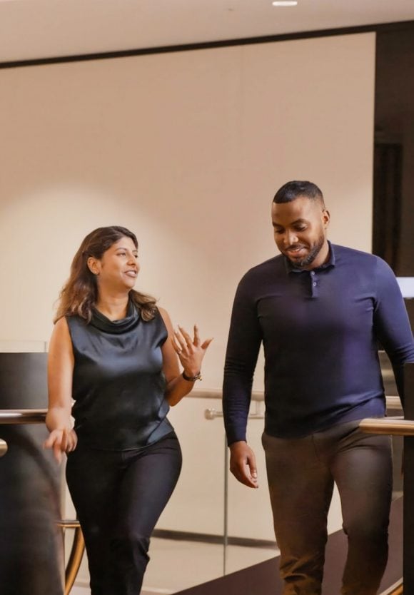 Two people walking in a room