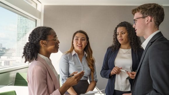 Students discussing with teacher
