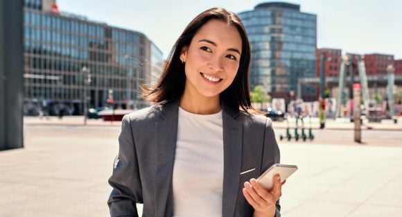 Holding phone and smiling