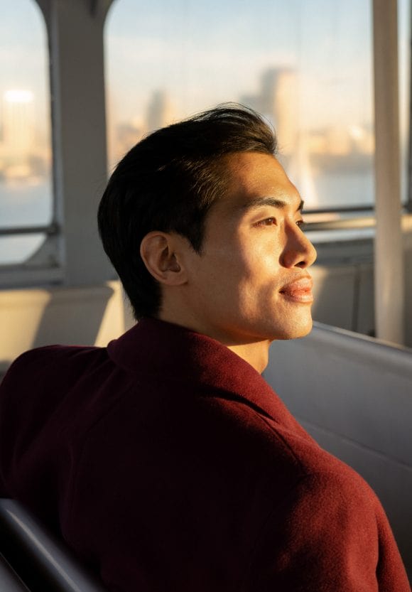 Man on ferry in New York looking for banking jobs